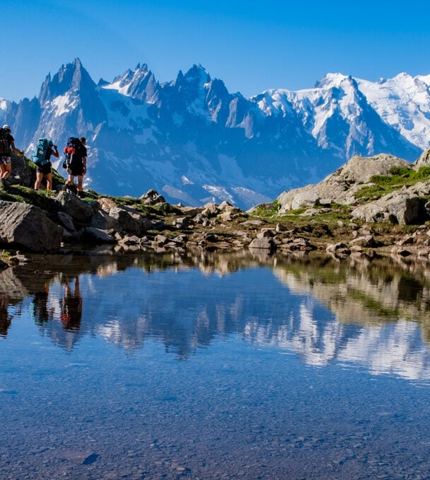Group of happy hikers on TMB highlights