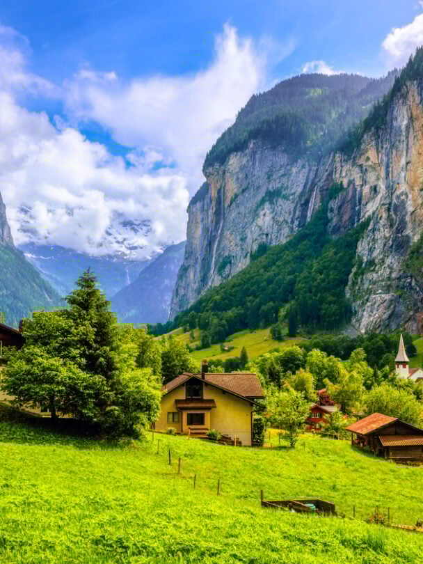 Hikers on a trail beside the Oeschinen lake, Swiss Alps.