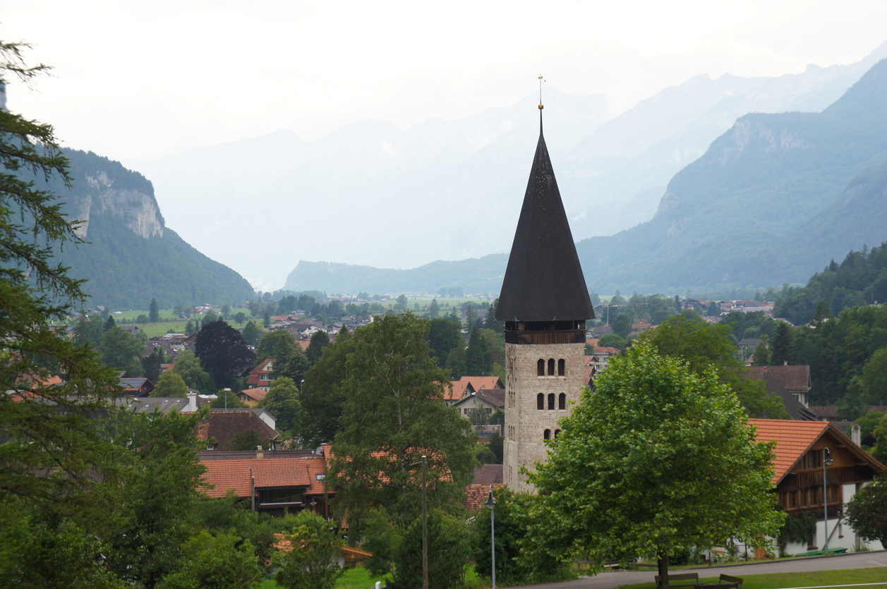 The vedute of the town of Meiringen in the Swiss Alps with its recognizable bell tower.