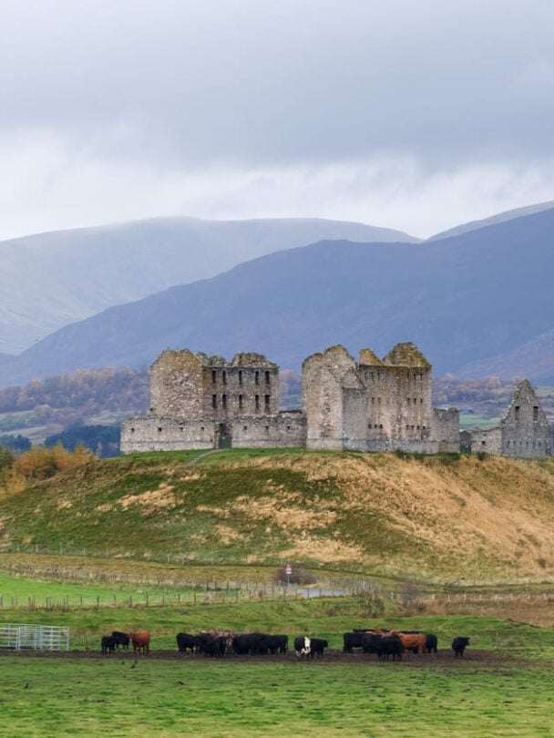 Two hikers crossing a shallow river