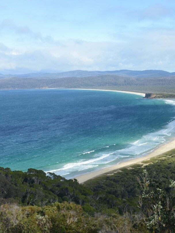 Hikers tackling the reggae shoreline in Beowa NP.