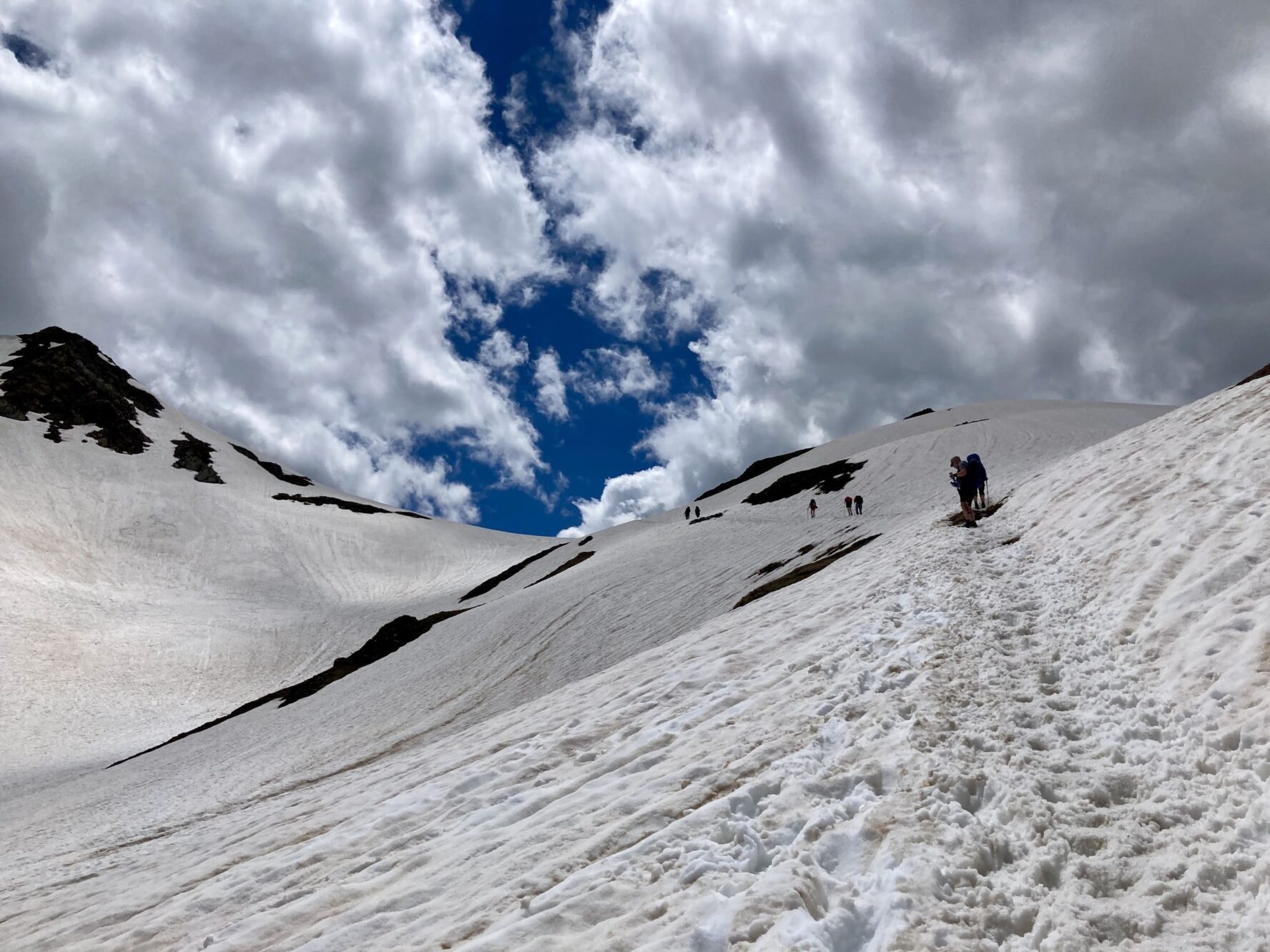 Snowy Alps and hikers
