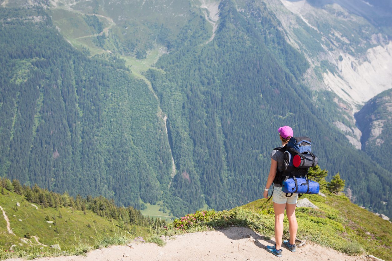 A hiker taking in the view of the mountains along the TMB.