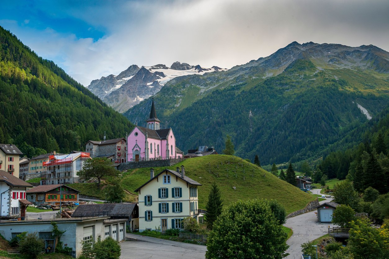 The village of Trient with a characteristic pink church, in the French Alps.