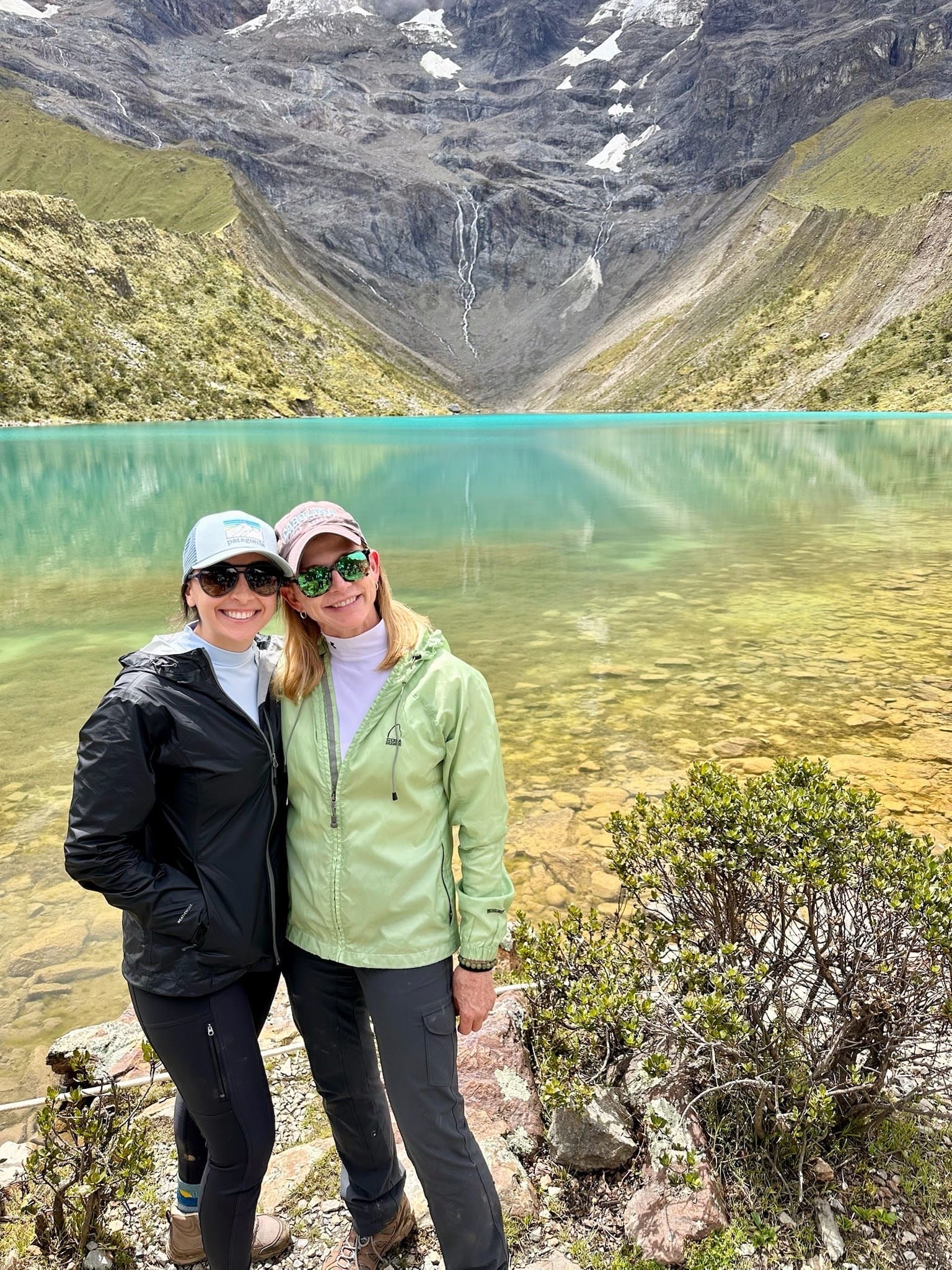 Two women on a bright day by lake