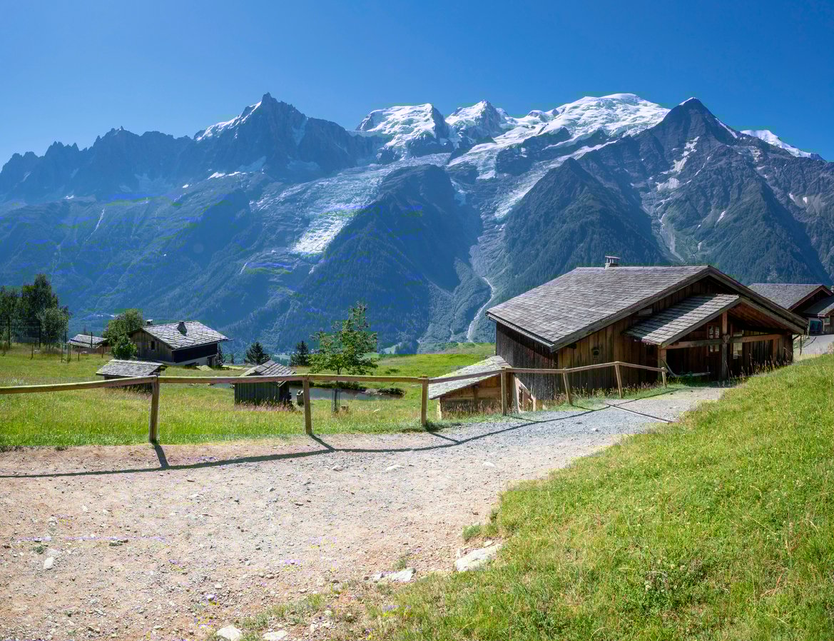 Wooden houses and lofty peaks, village of Les Houches, France.