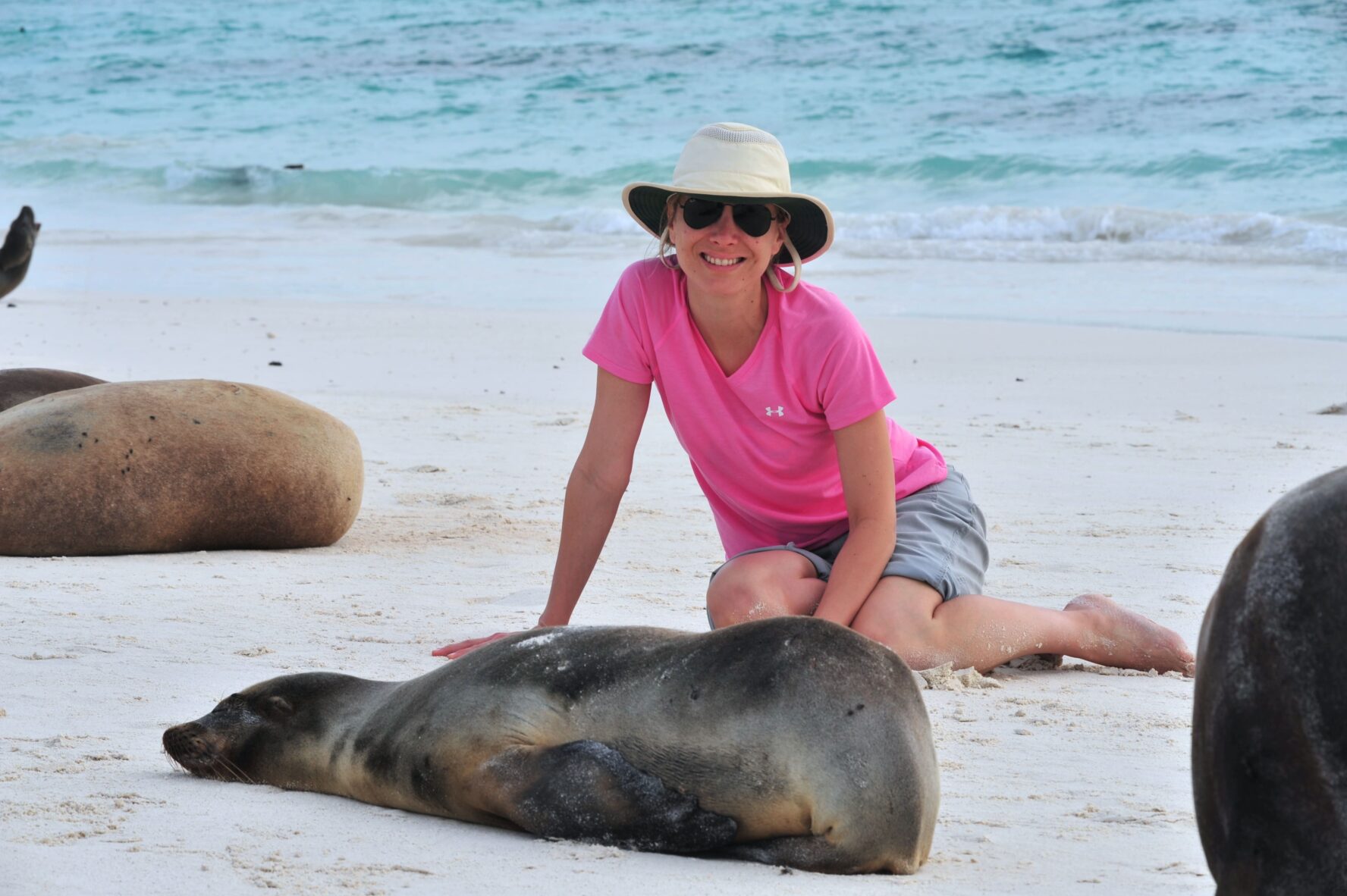 Woman next to a sea lion in Galapagos