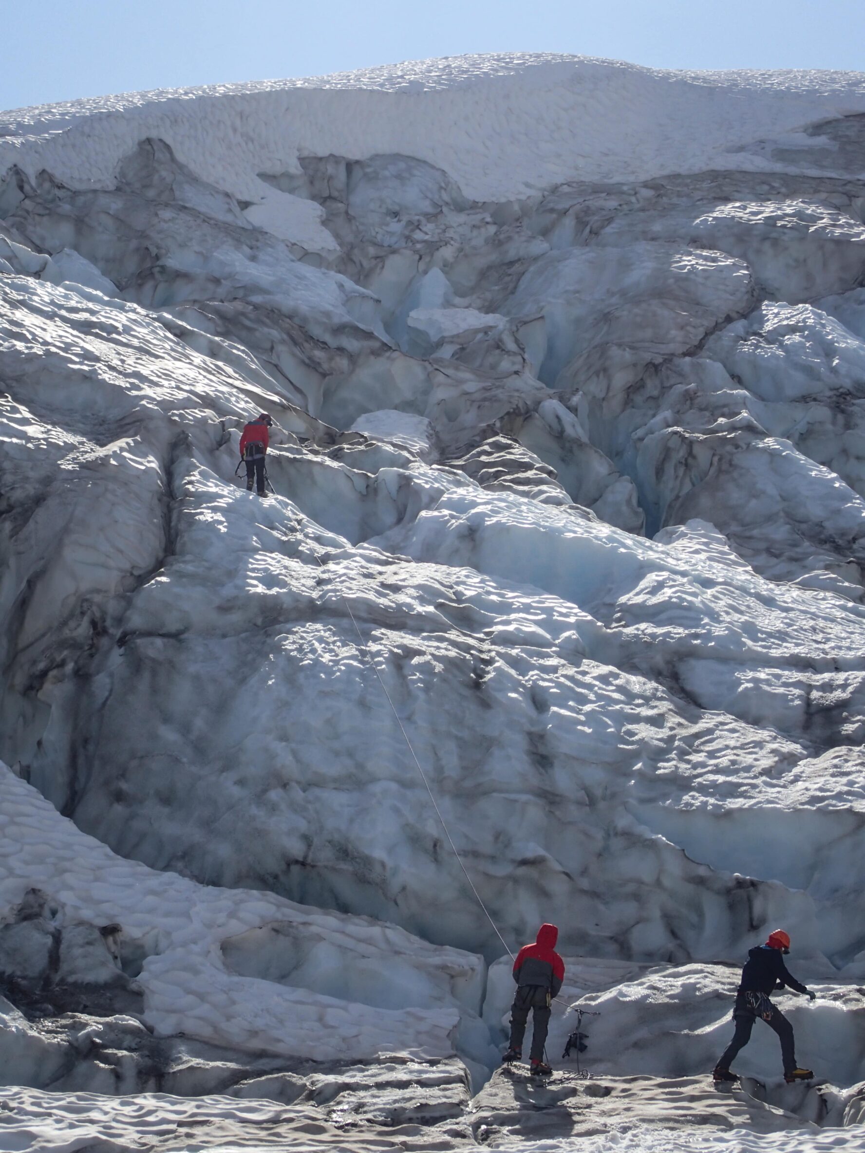 Mountaineers rappelling down a glacier in Alaska