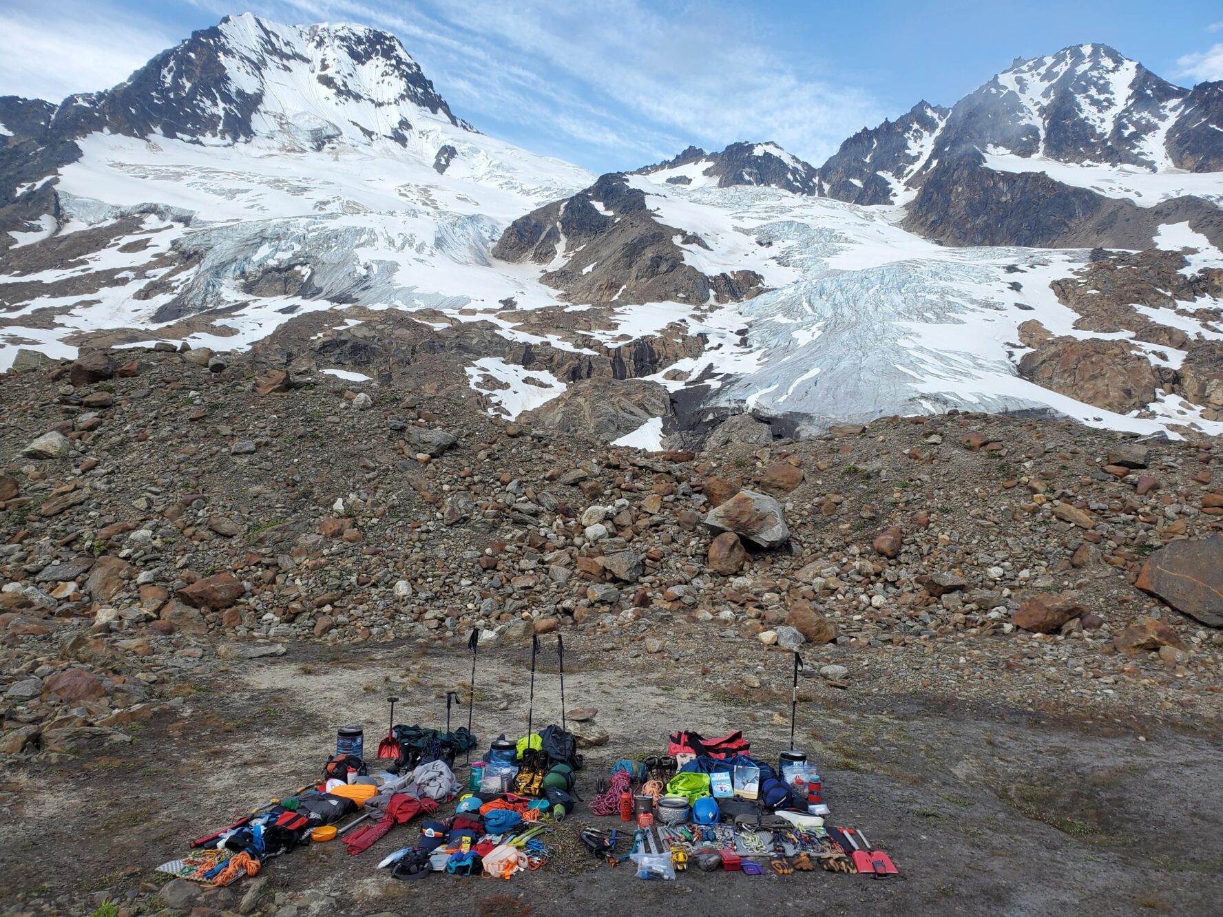 Mountaineering gear spread out near an Alaskan glacier