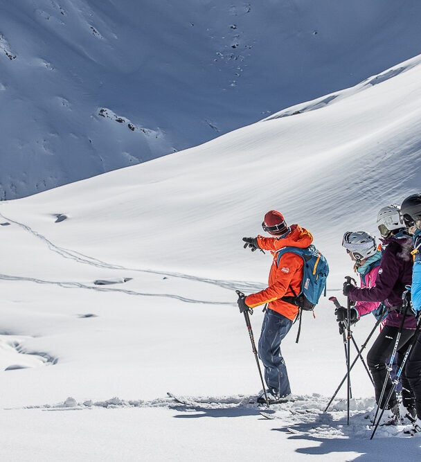 Three backcountry skiers skinning up a slope in Silvretta, Austria.