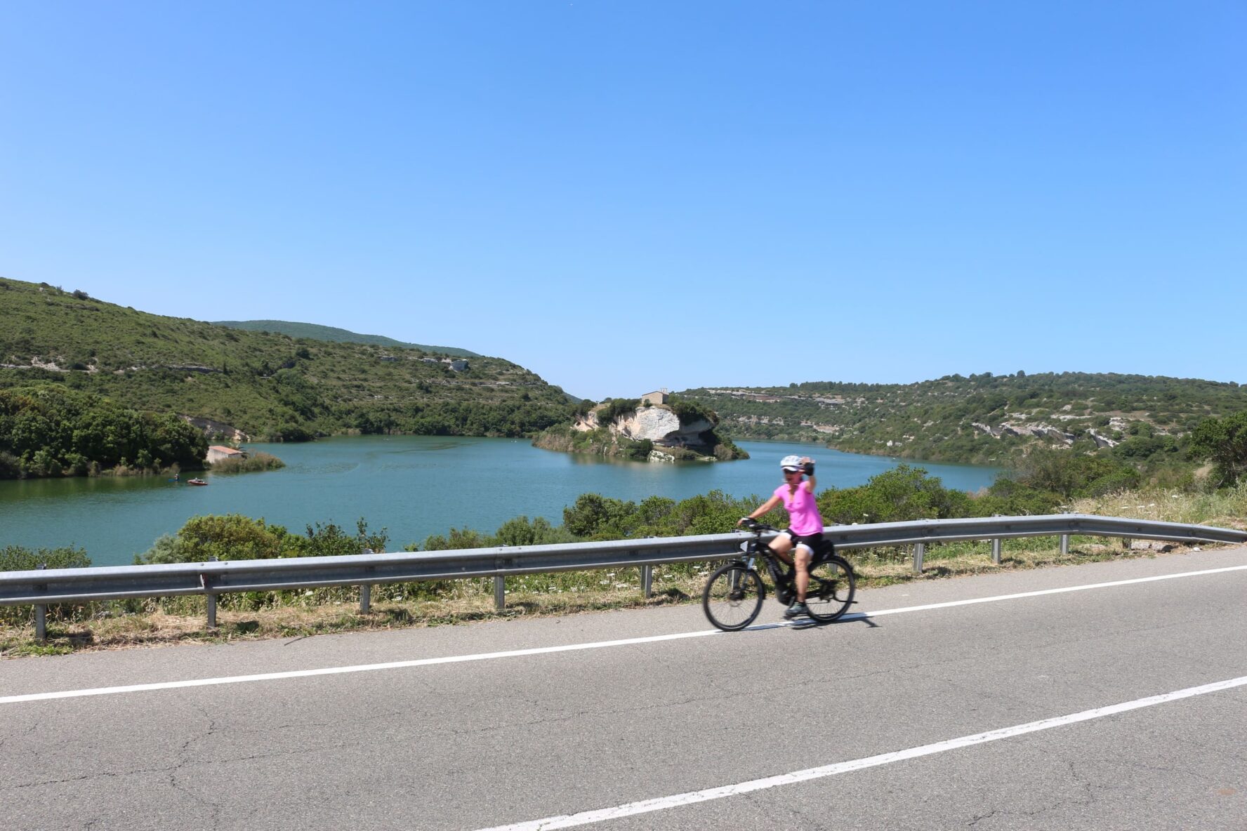 Cyclist next to a lake in Sardinia