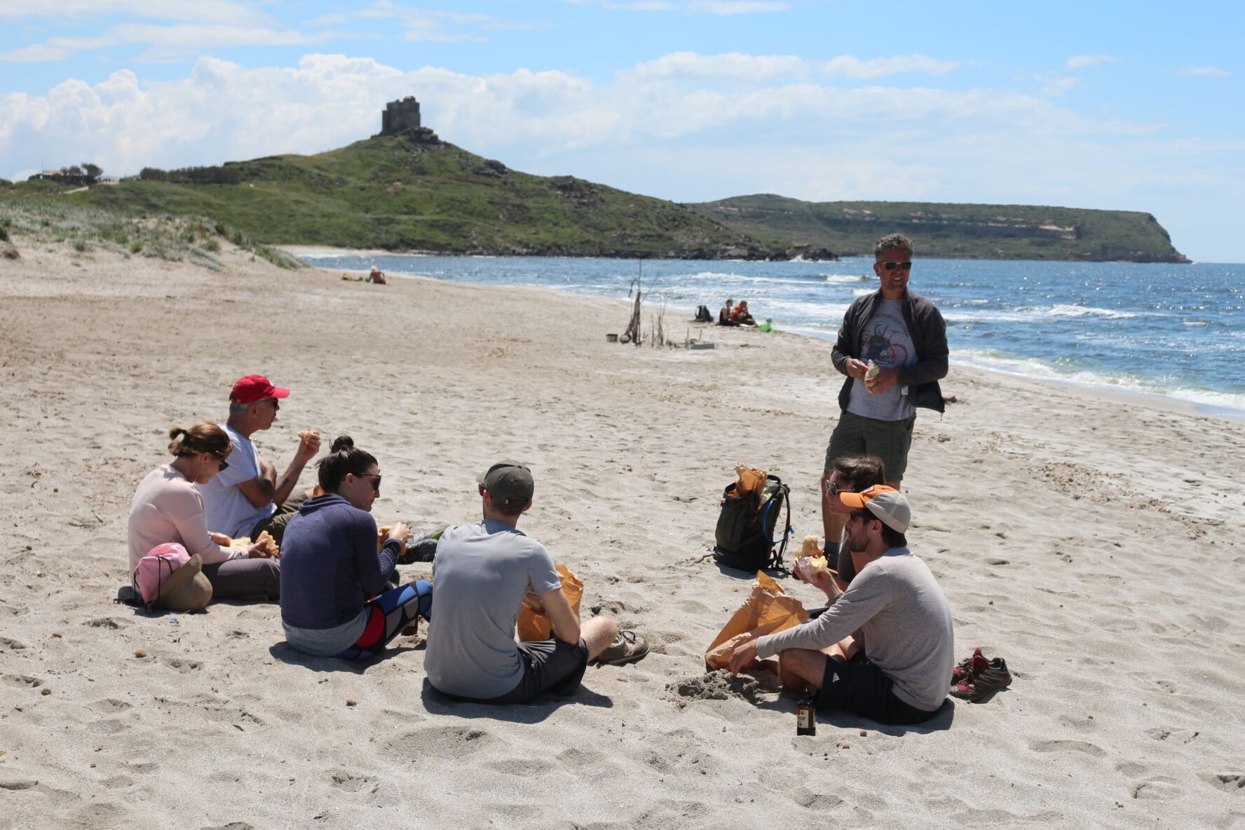 Cyclists resting on a beach in Sardinia