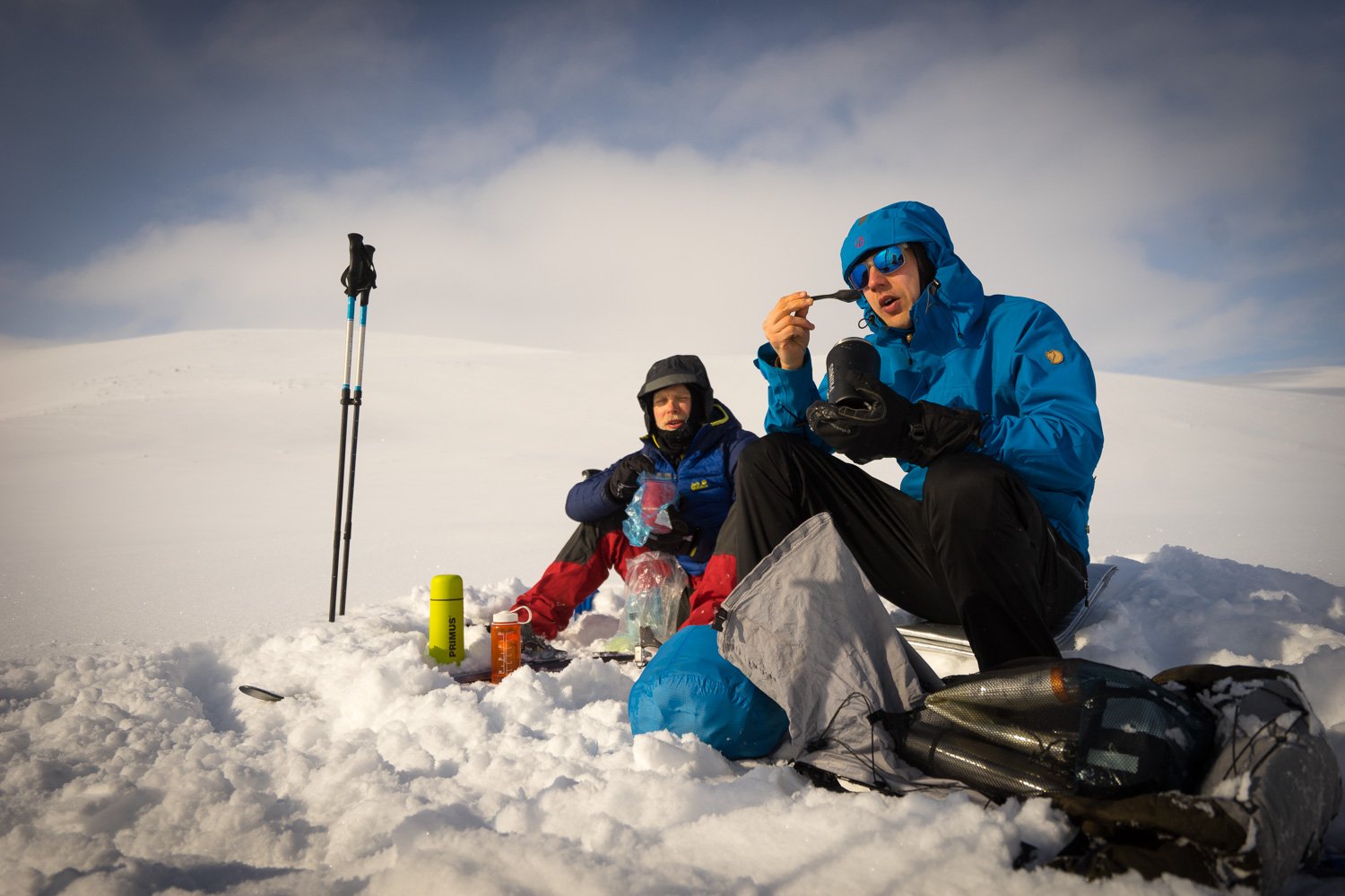 Skiers in Halti eating a warm meal.