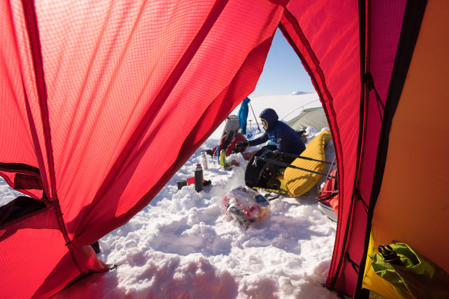 Skiers resting photographed from a tent in Halti, Finland.