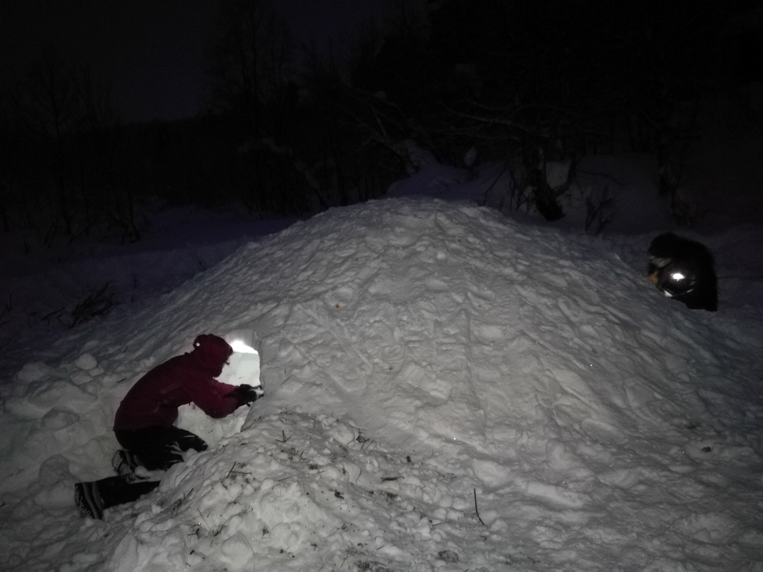 Skiers resting in a quinzee in Lemmenjoki NP, Finland