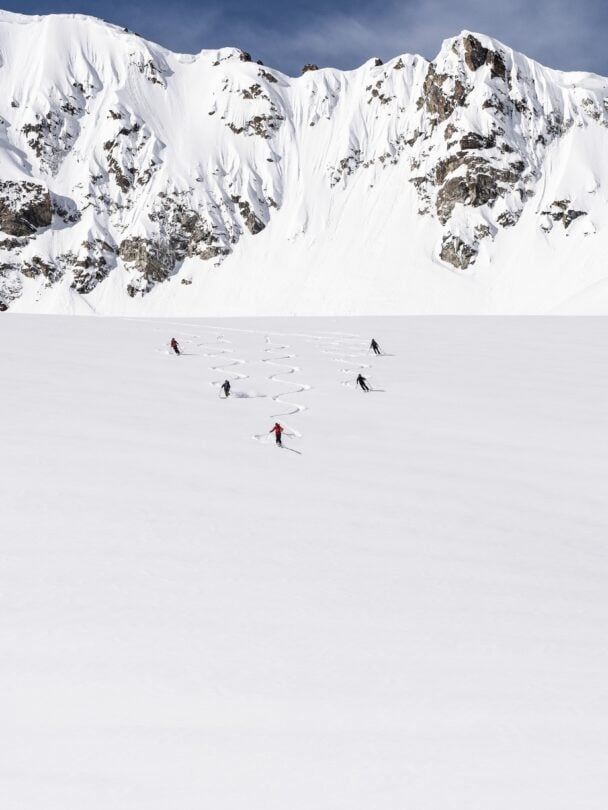 Three backcountry skiers skinning up a slope in Silvretta, Austria.