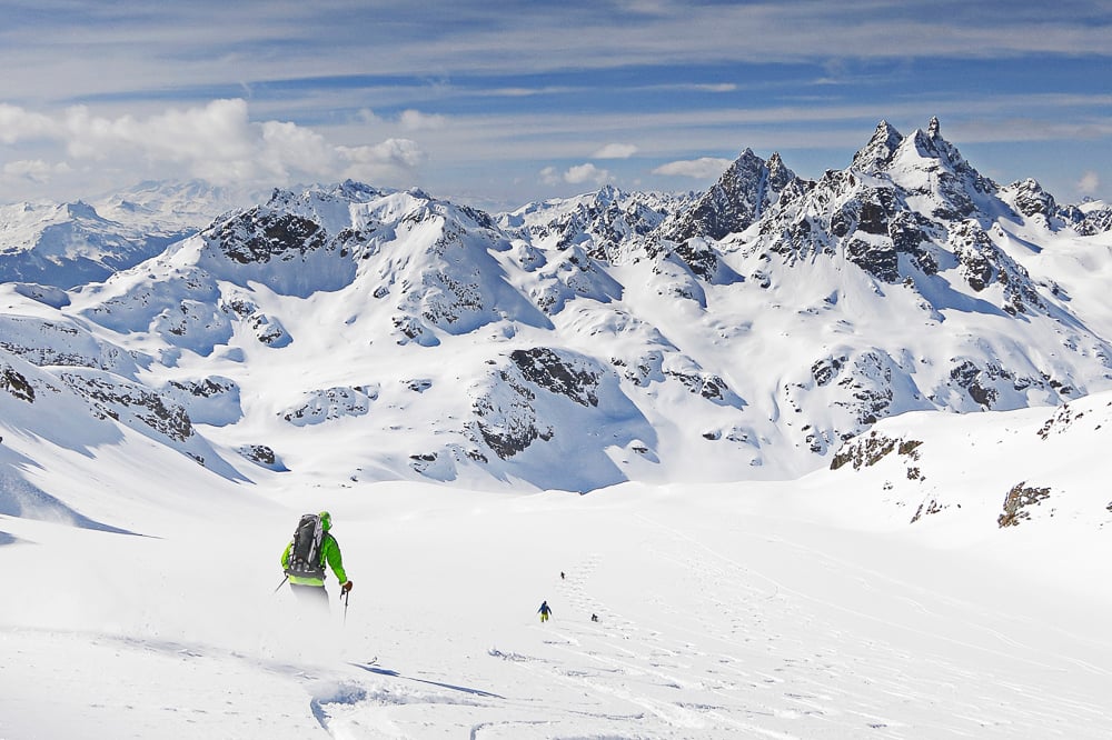 Off-piste skiers on a wide open slope in the Silvretta Alps, Austria.