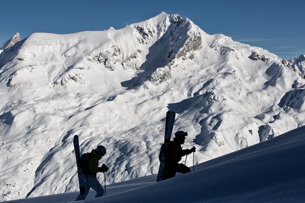 Some tourers in a shadow climbing a peak near St. Anton am Arlberg
