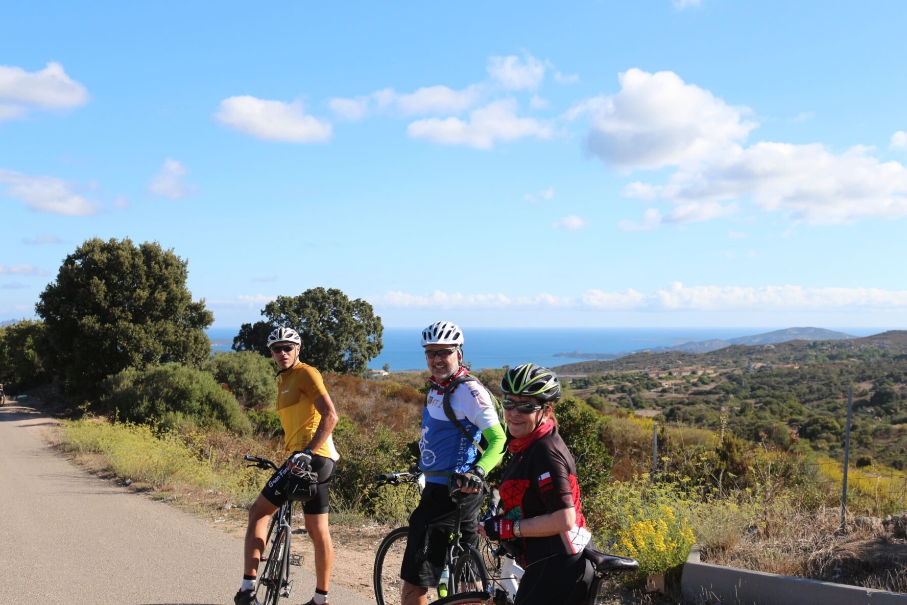 Three happy cyclists in the Mediterranean