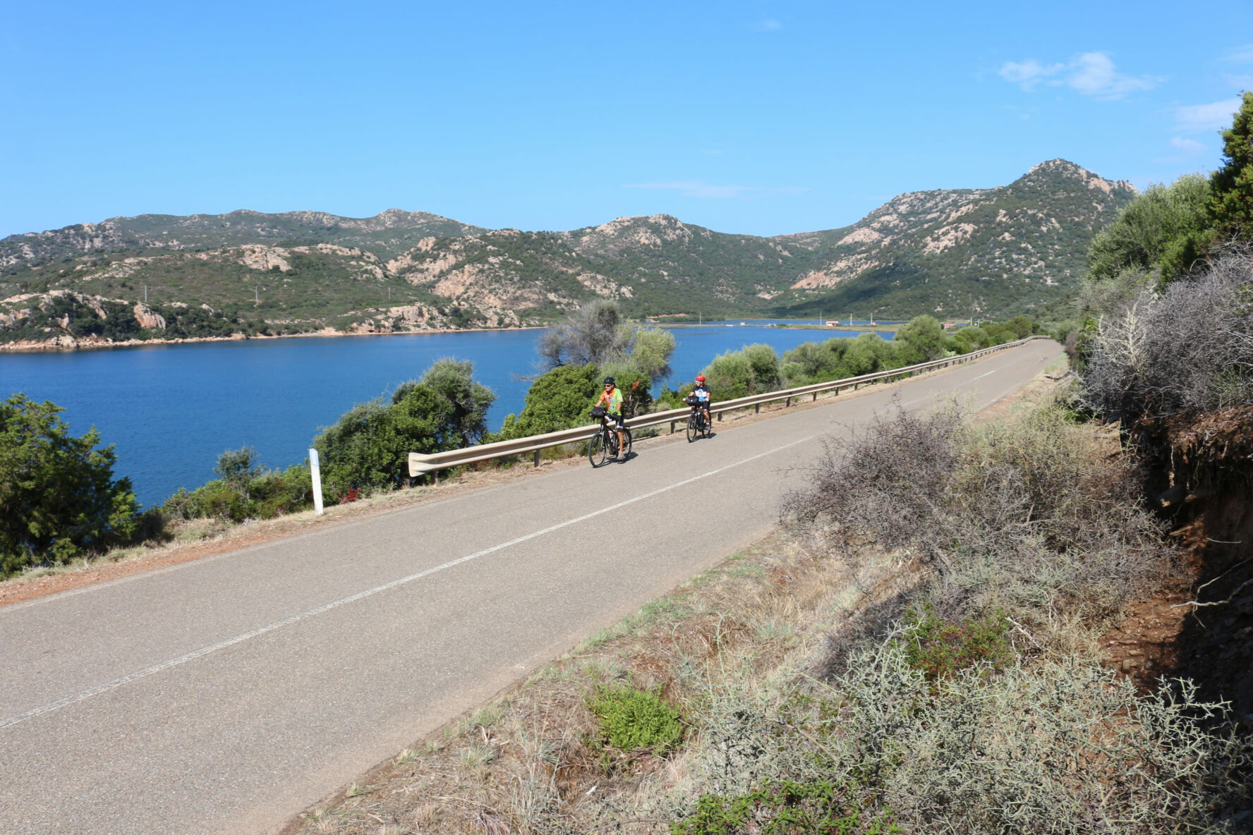 Two cyclists on a sunny day in Sardinia