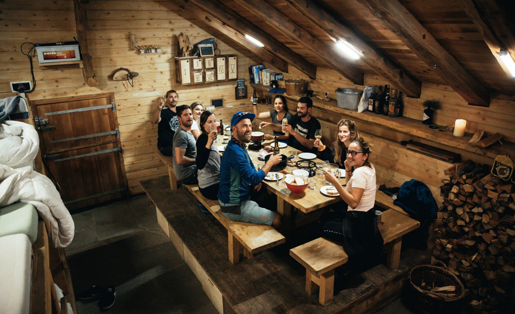 Haute Route e-mountain bikers enjoying dinner in a cozy hut.