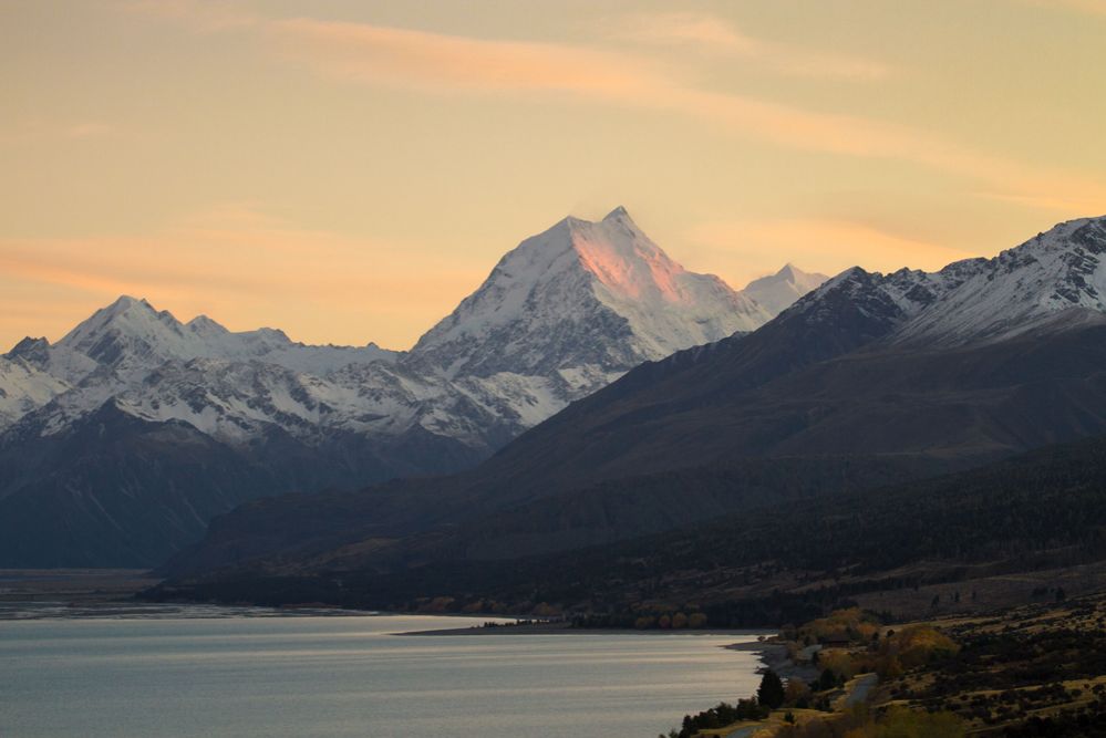 Cyclists standing near the Elephant Rocks in New Zealand.