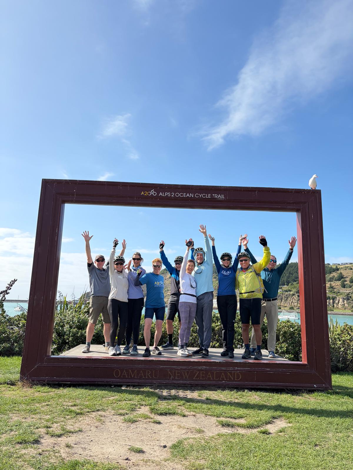 happy group cyclists alps ocean