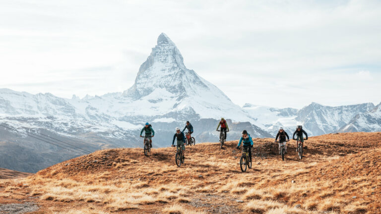 E-mountain bikers near Matterhorn, Swiss Alps.
