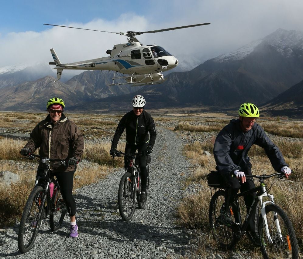 Cyclists starting their Alps to Ocean Trail tour after a helicopter ride to Mt Cook.