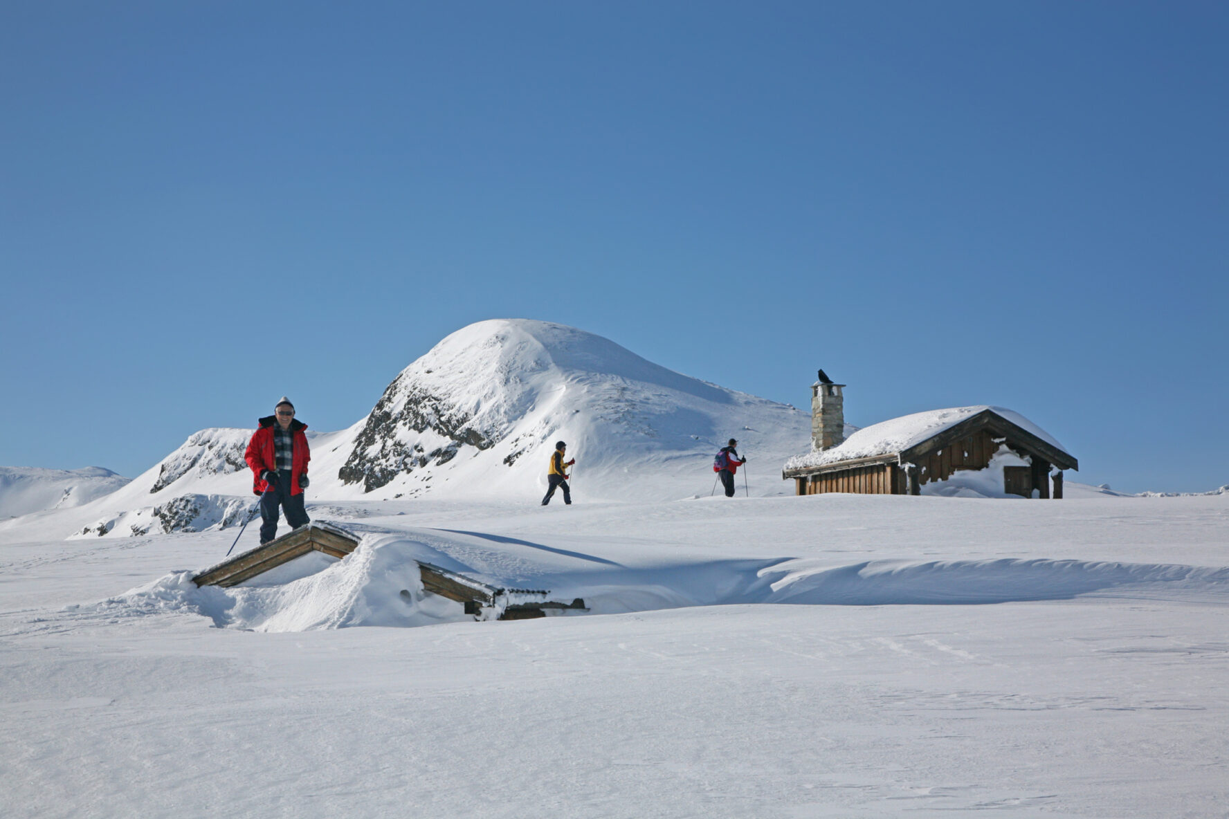 Huts protruding from snow along the Jotunheimen Haute Route, Norway.