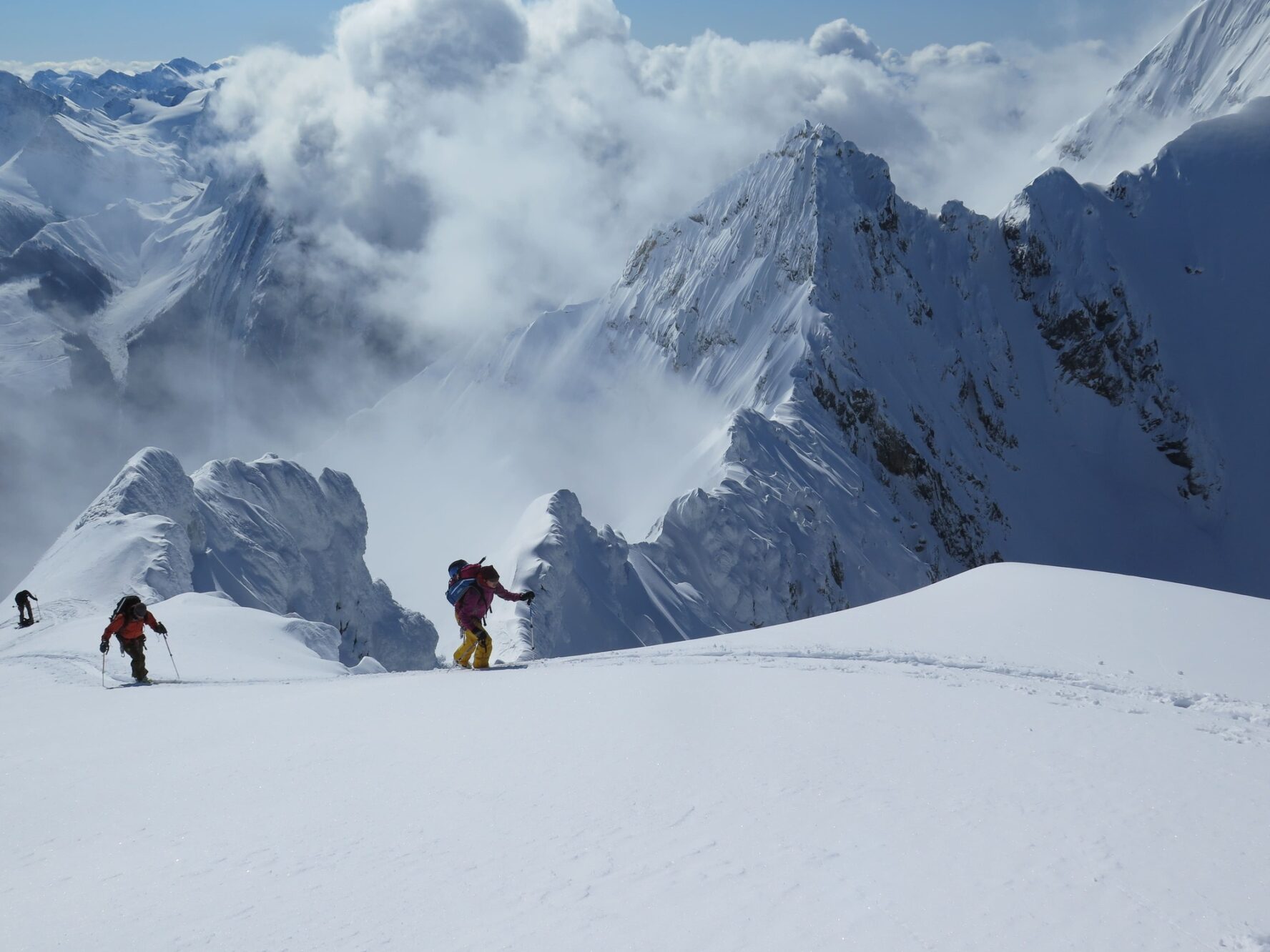 Skiers skinning up the Icefall Traverse