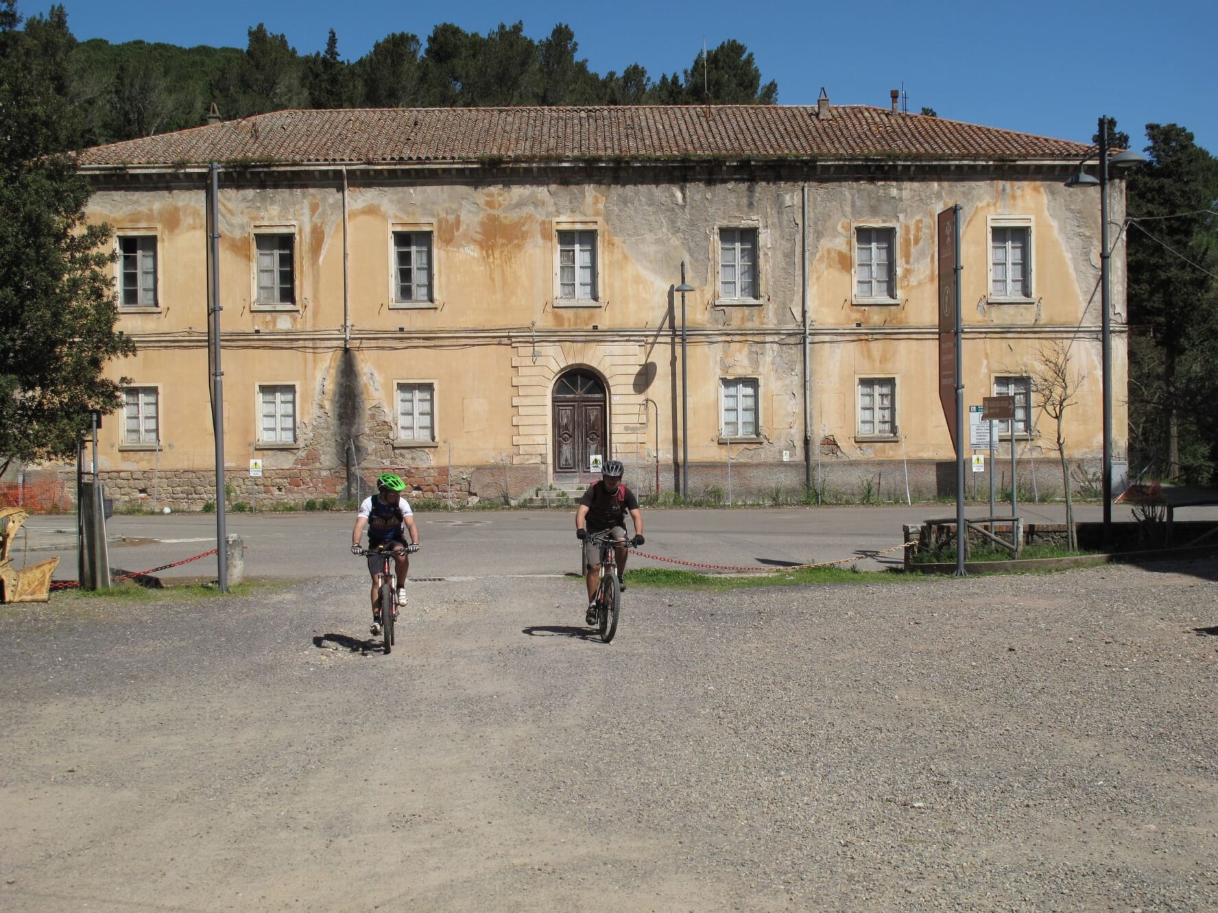 Two cyclists in a Sardinian village