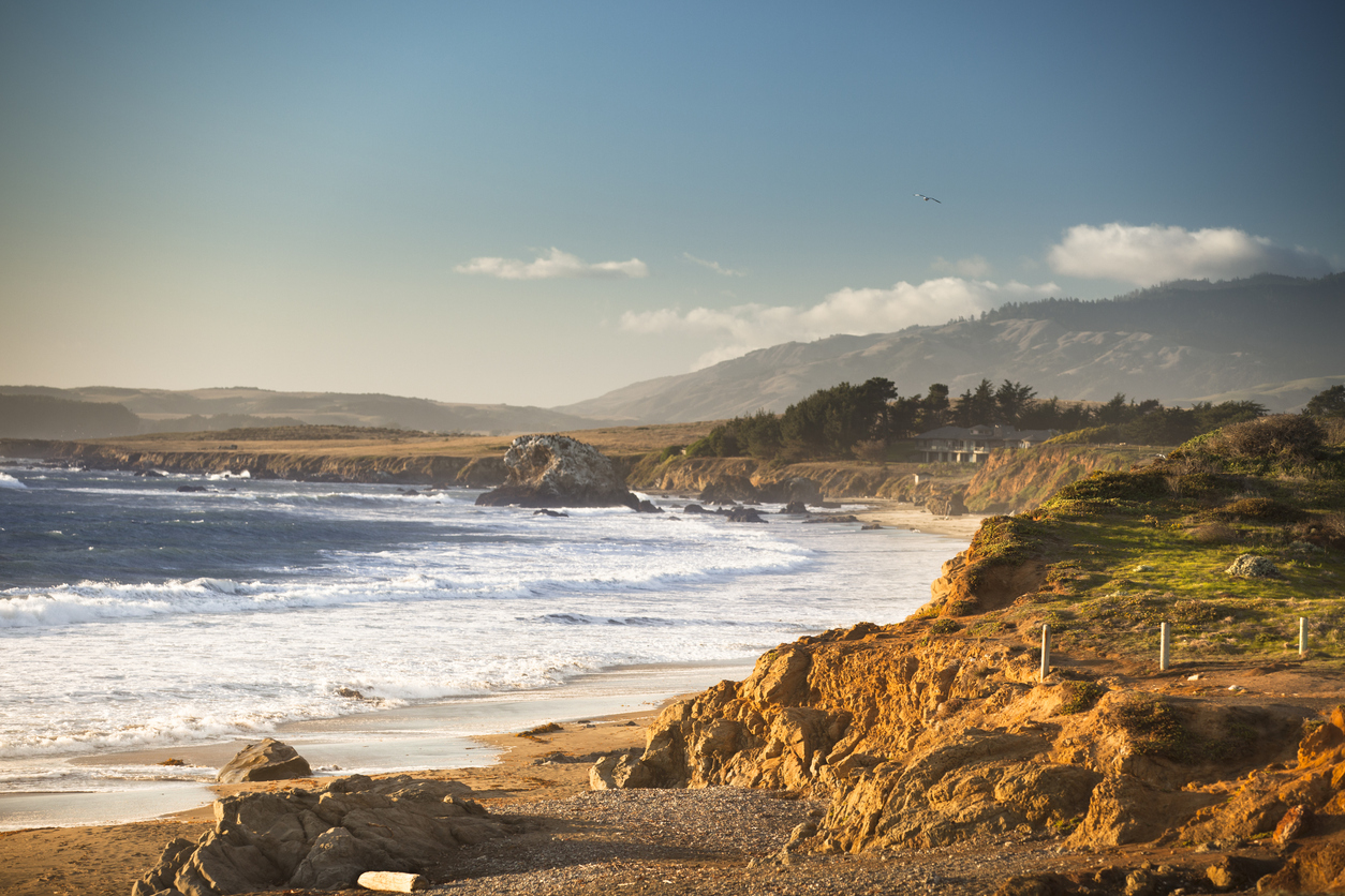 Pacific ocean waves crash the rocky beach coast in California by the Cabrillo highway US 1