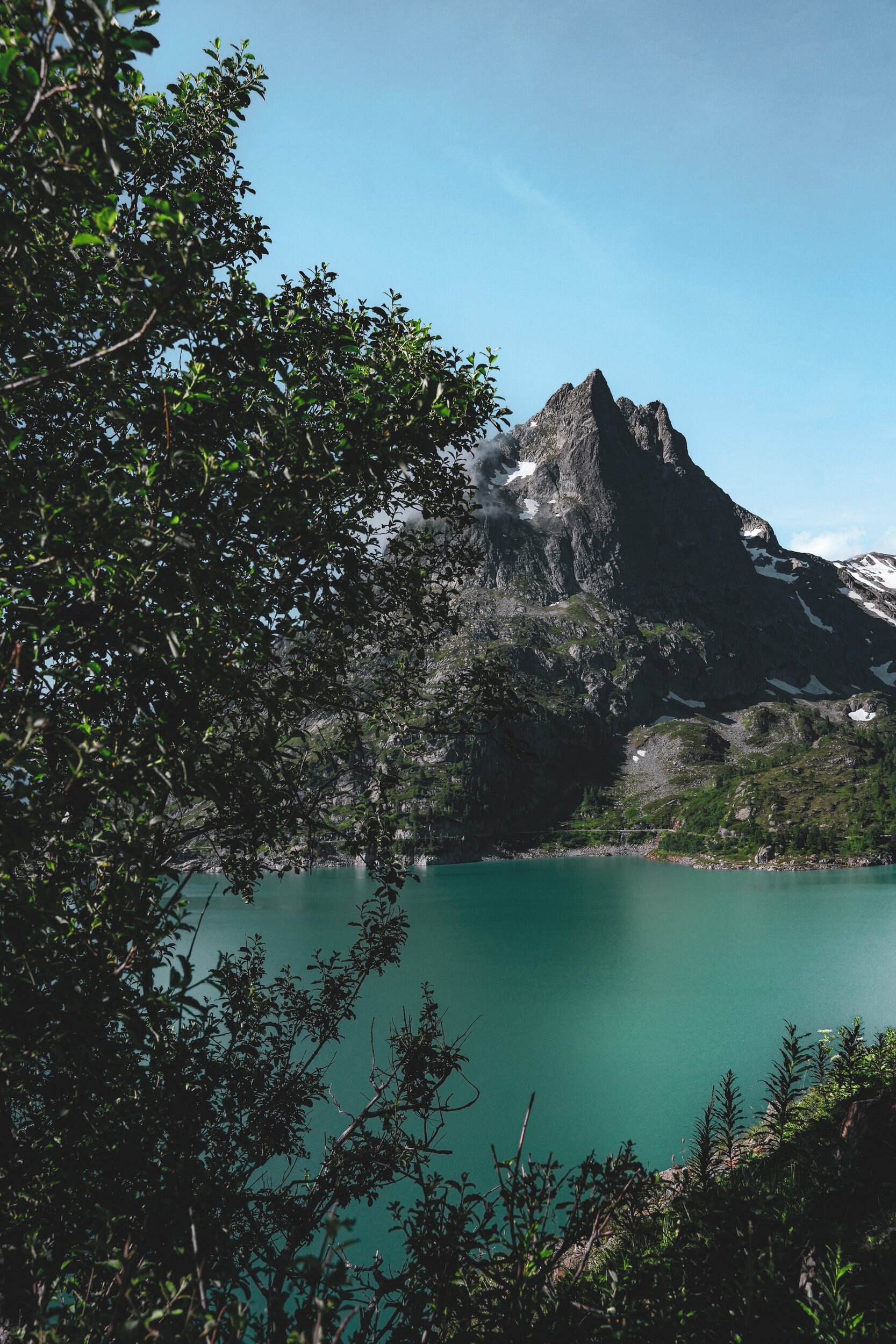 View of Emosson lake between trees