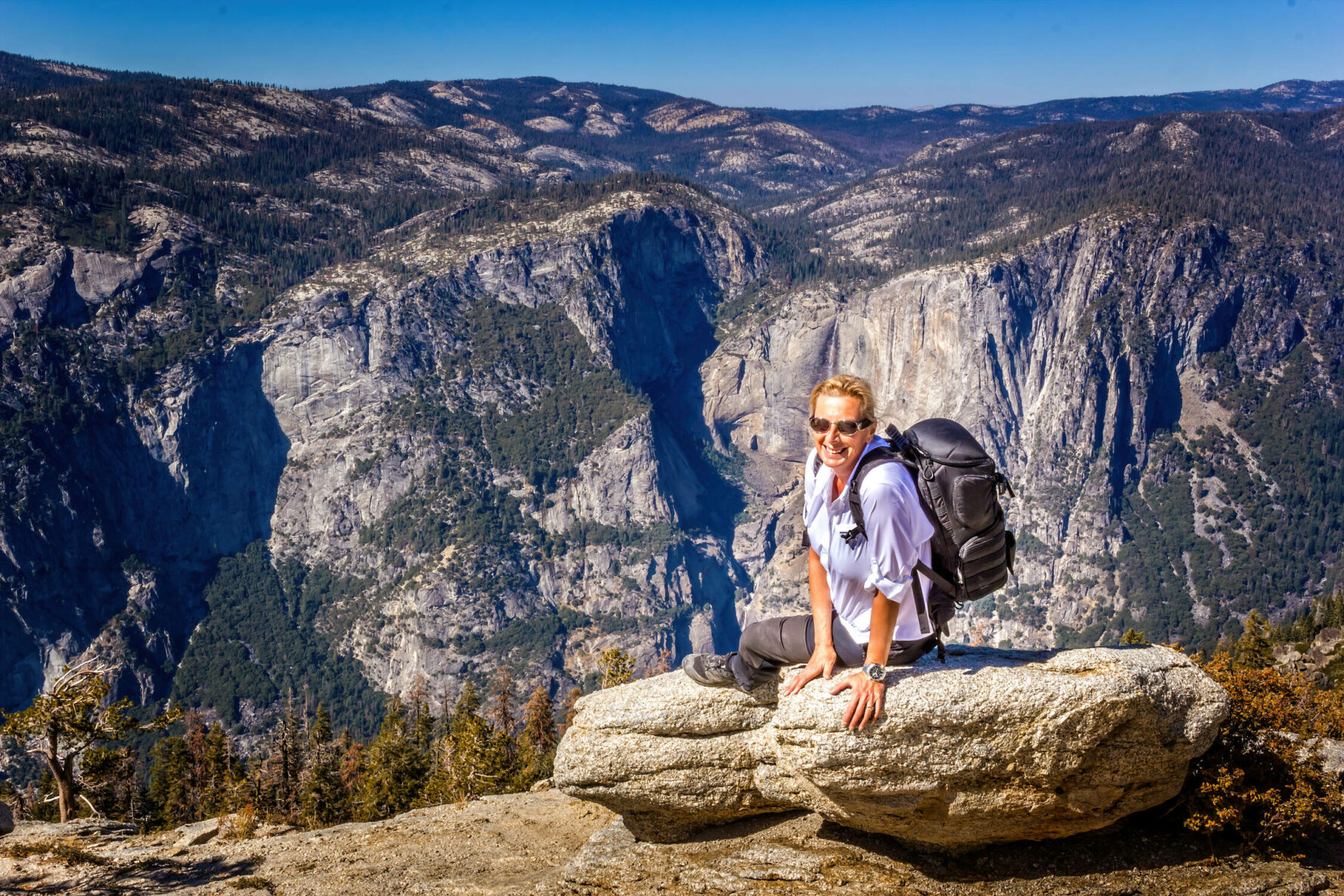 A hiker enjoying panoramic views in Yosemite.