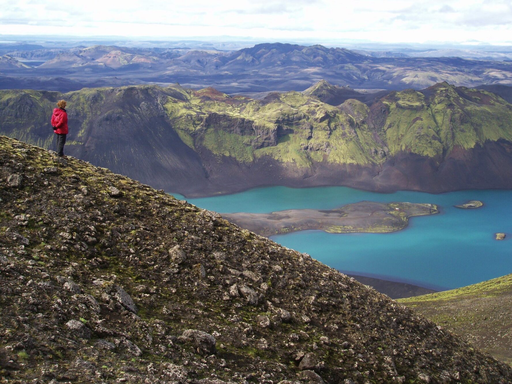 A hiker admiring a view over the Langisjor lake, in Iceland.