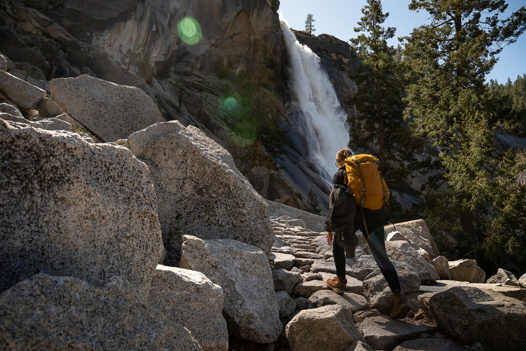 A hiker beside the Nevada Fall in Yosemite.