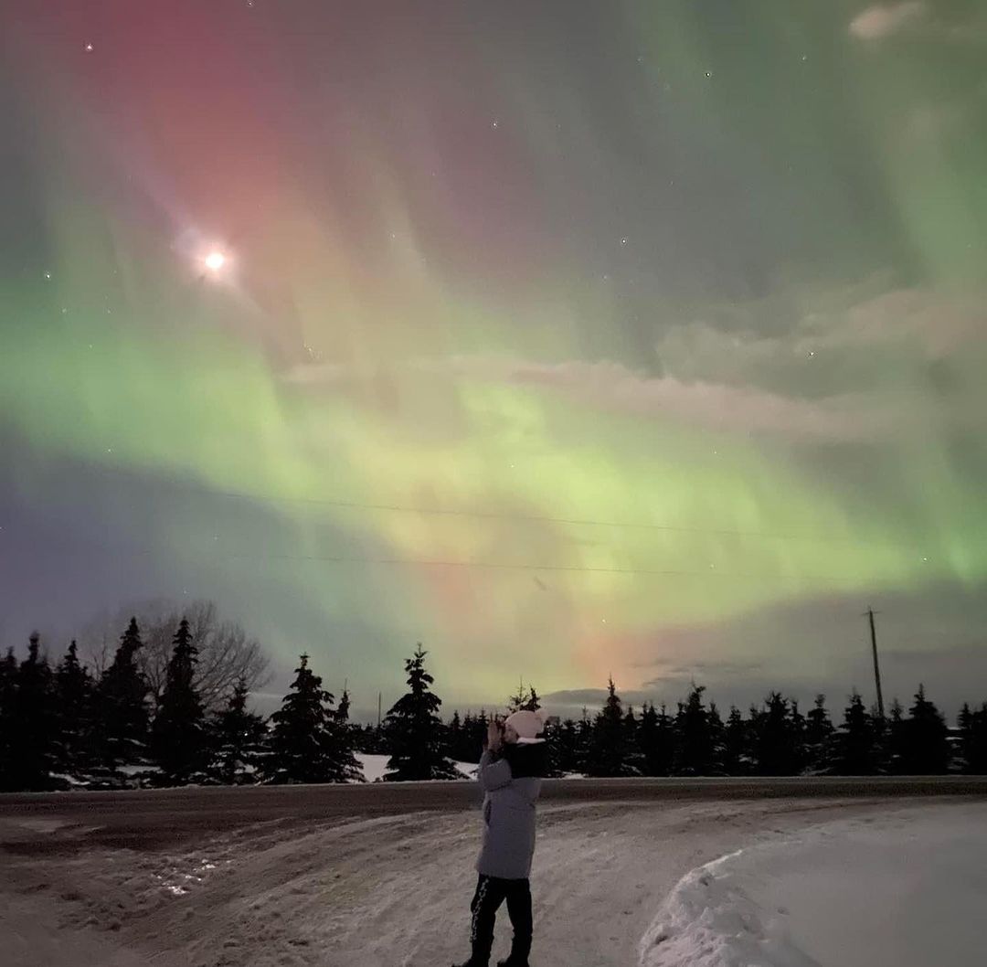 Woman enjoying Northern lights