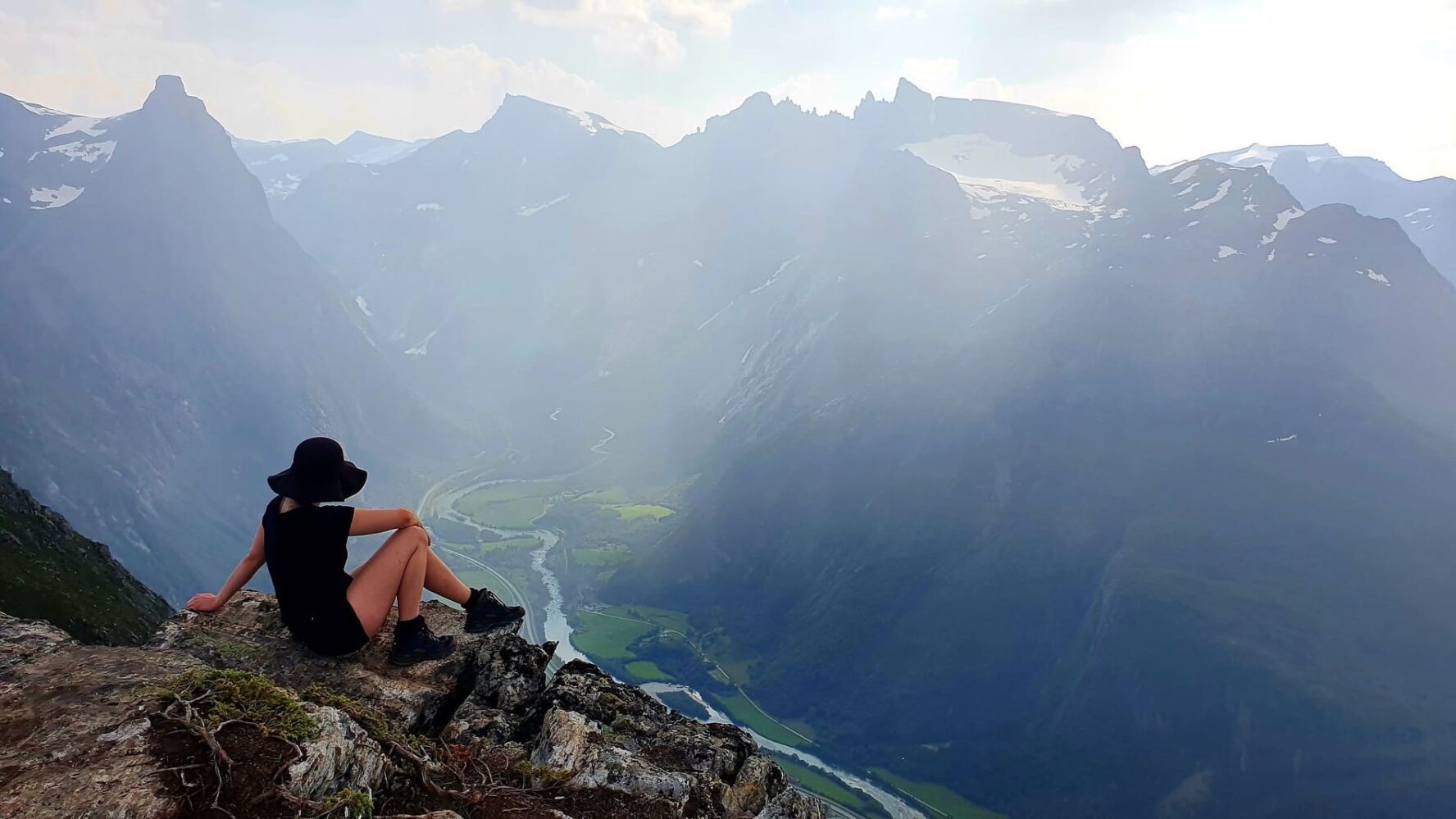 Woman relaxing on the mountain top in Norway