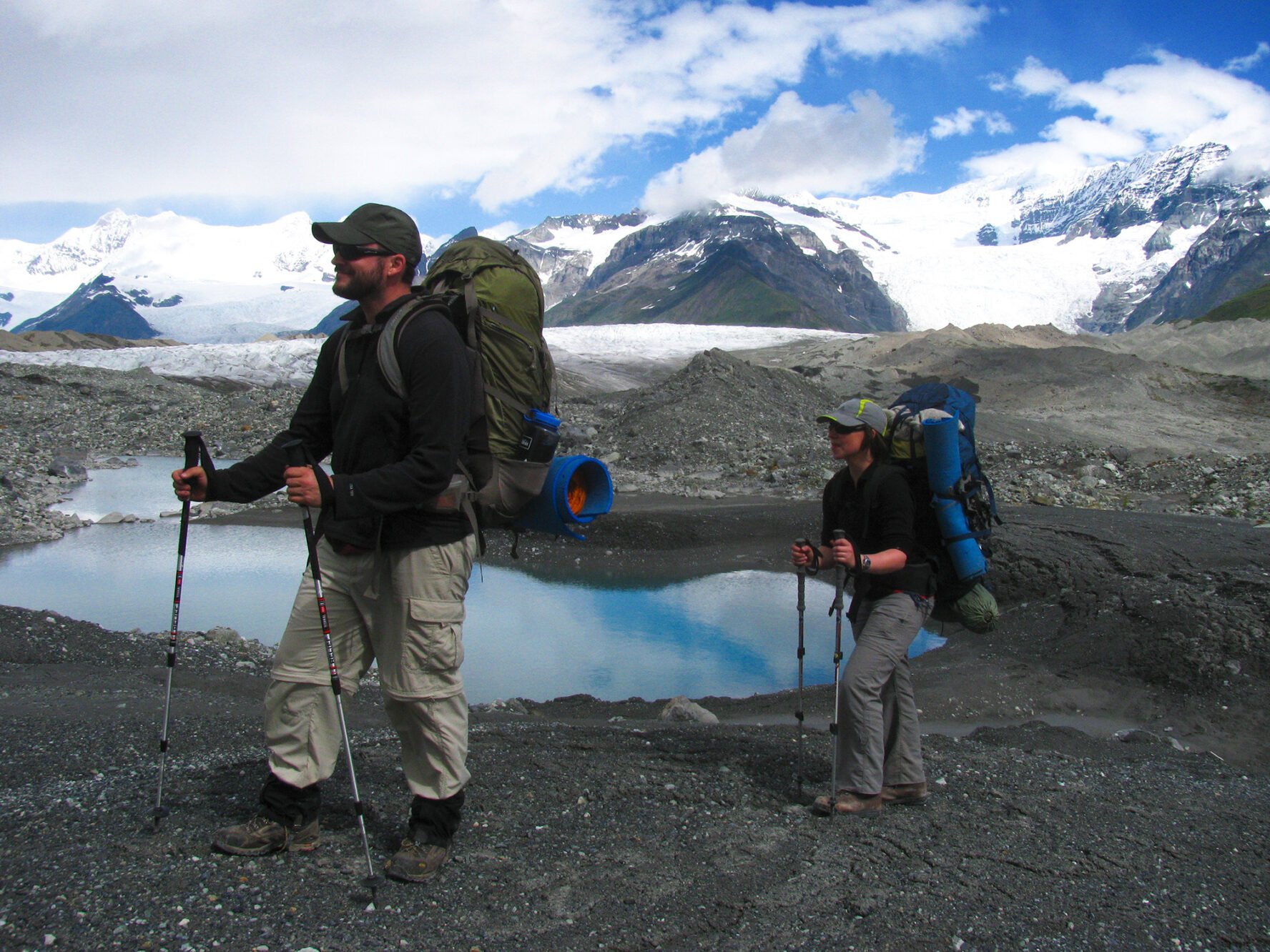 Backpackers crossing a moraine at the Gates Glacier