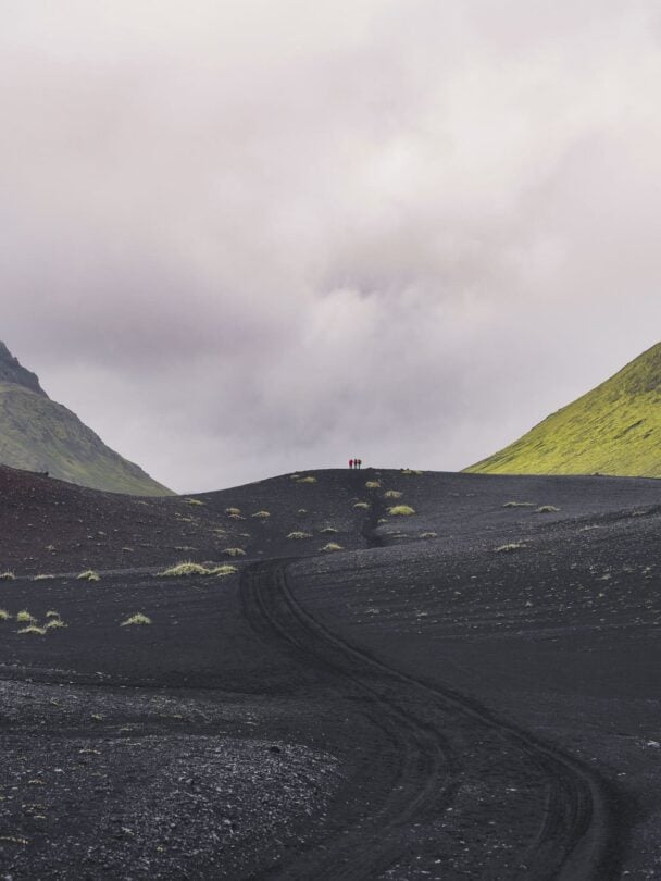 Hikers traversing the river crossing in Iceland.