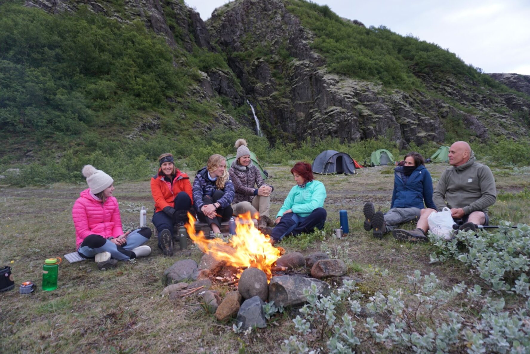 Hikers gathered around a campfire in the Icelandic wilderness,