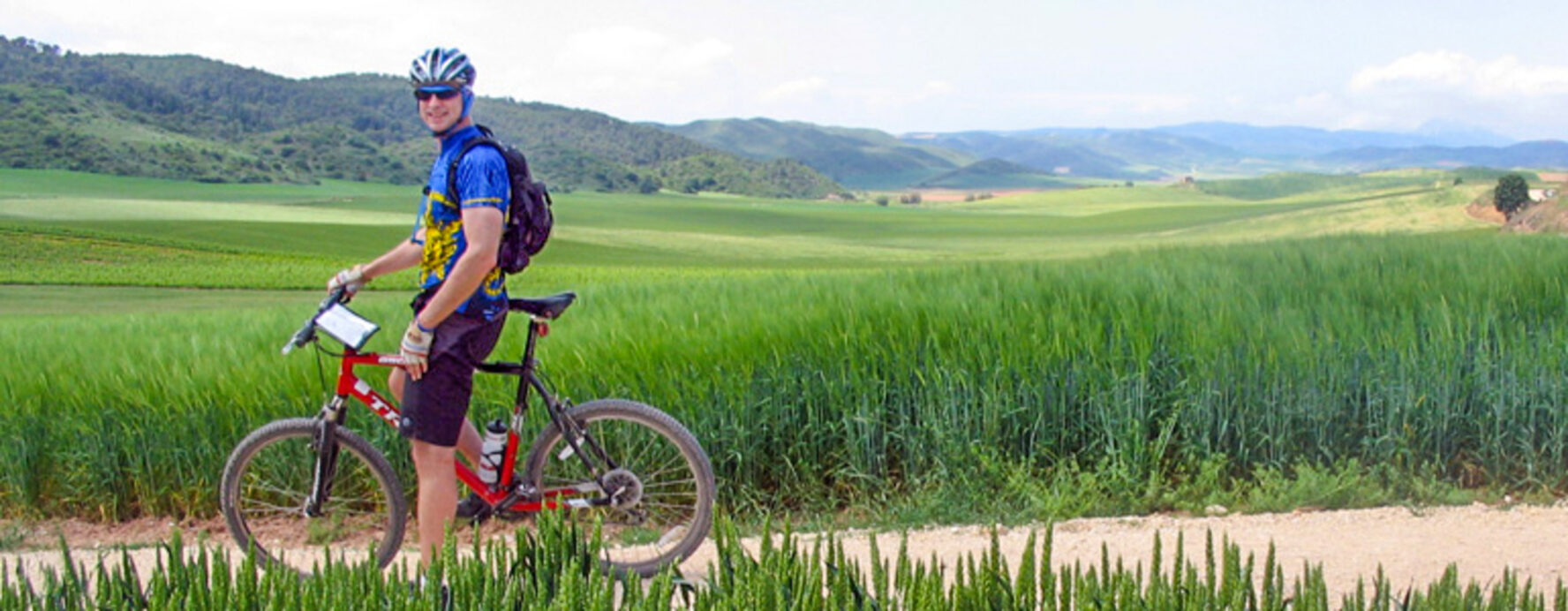 Cyclist riding near Pamplona, along Camino Frances.