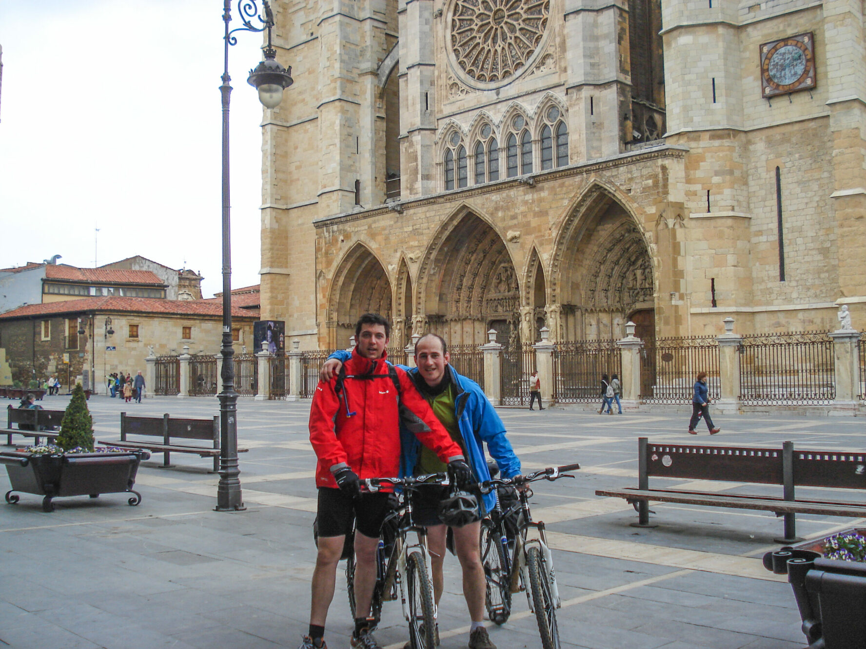 Cyclists posing for a photo in front of a church, during their Camino Frances cycling tour.