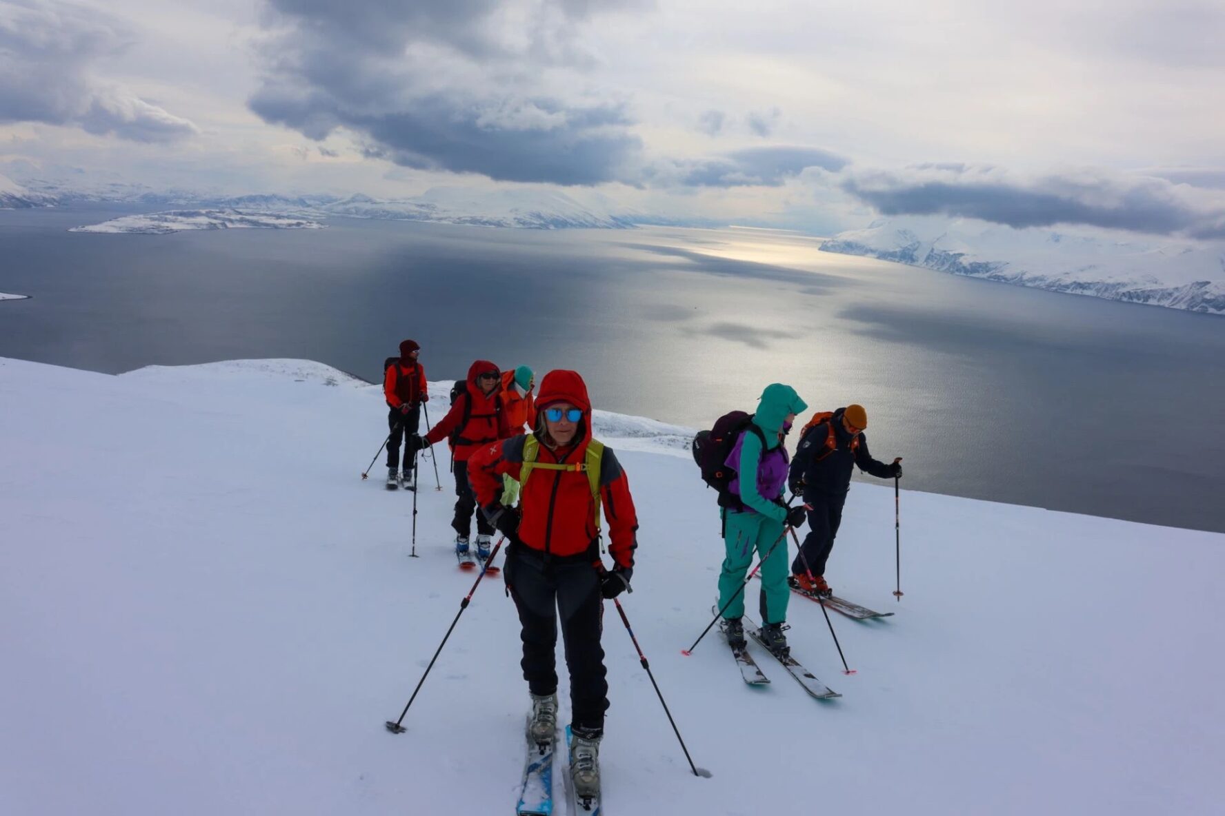 Fjord view and backcountry skiers in Norway