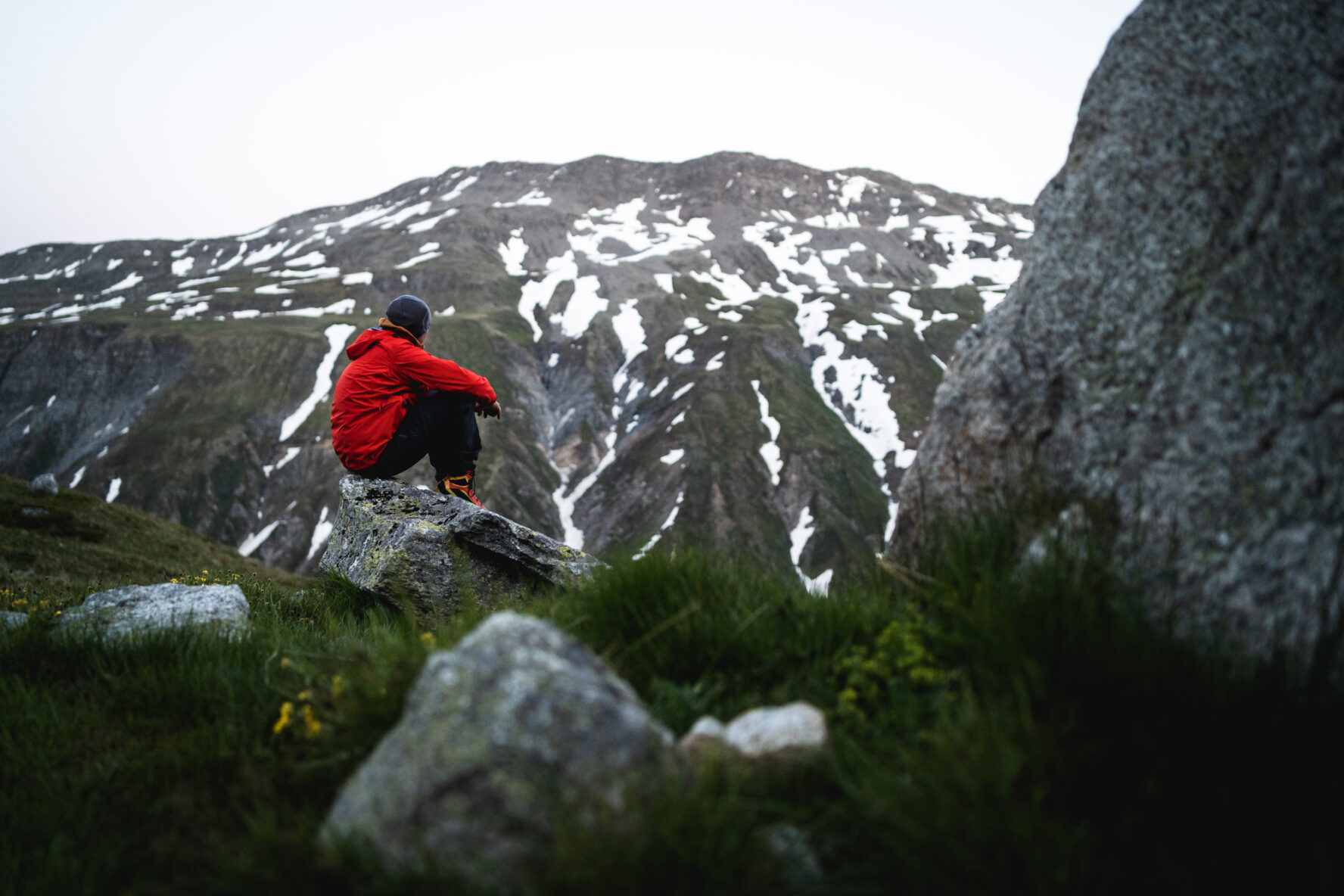 Hiker admiring the view along the Four Springs Trek in the Swiss Alps.