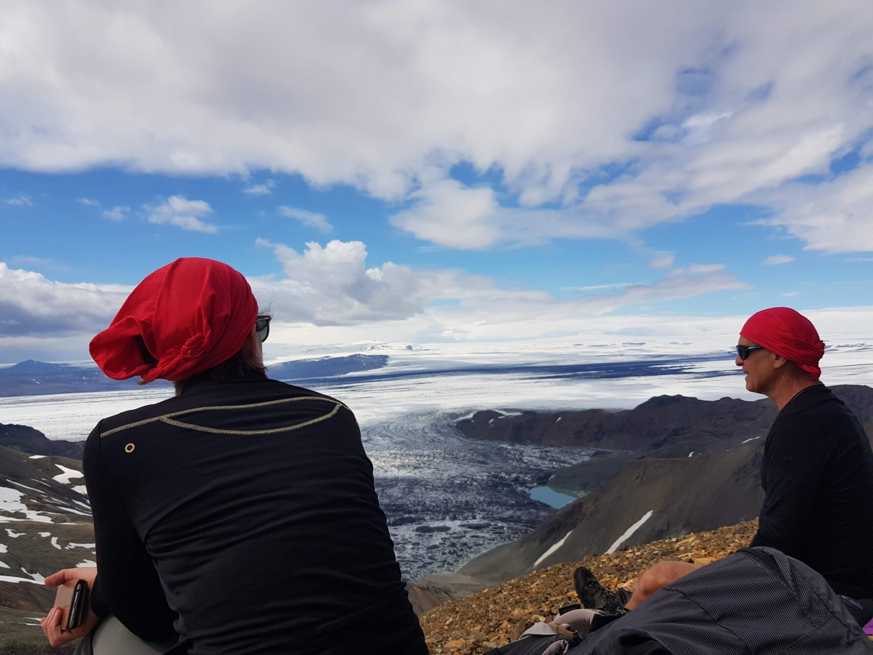 Hikers enjoying a view of an outlet glacier in Iceland.