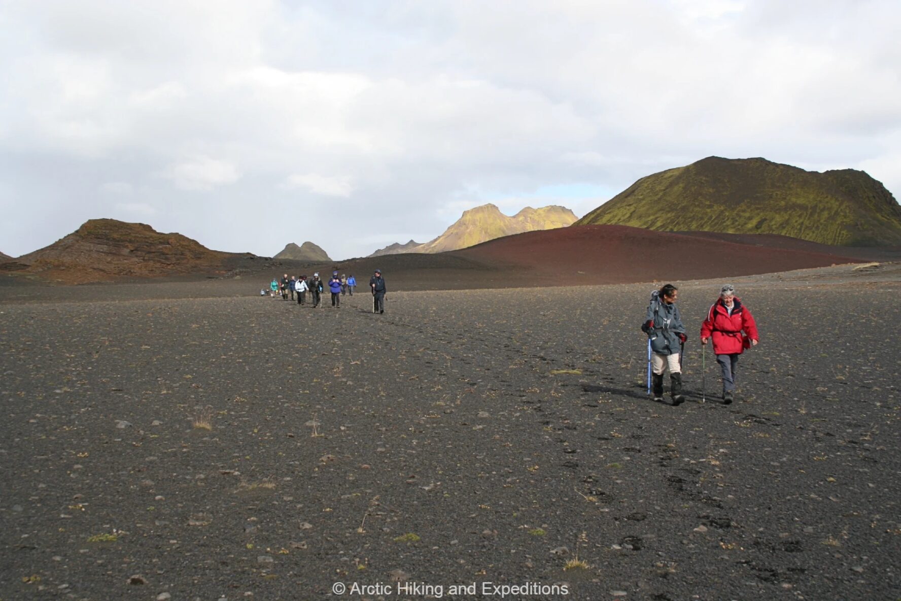 Hikers on volcanic soil
