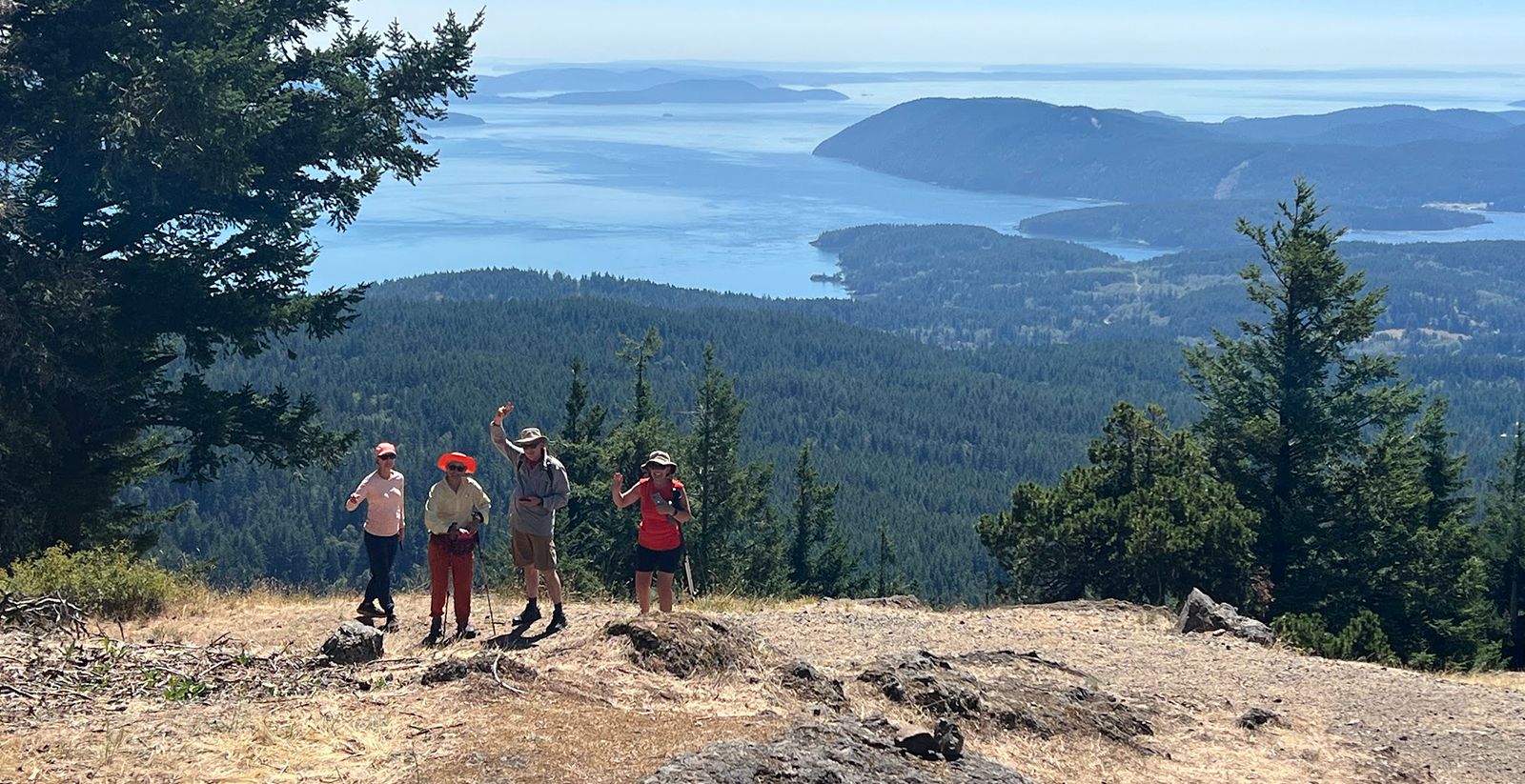 Hikers standing on the top of Mt Constitution in the San Juan Islands.