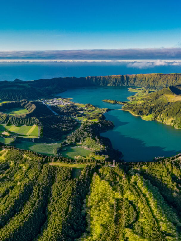 Hiker in a red jacket at the caldera on São Miguel island in the Azores